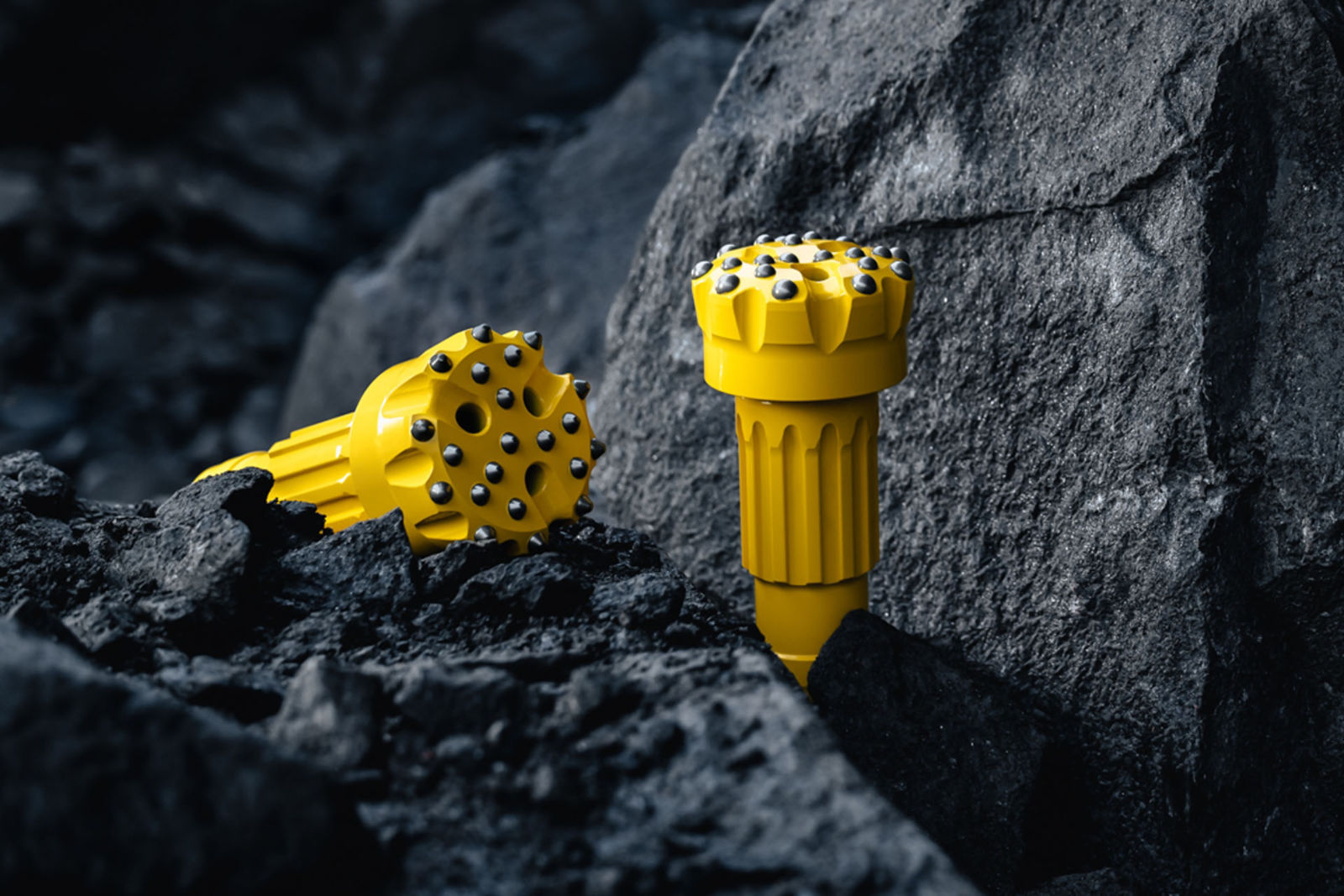 Epiroc DTH drill bits on rocks.jpg