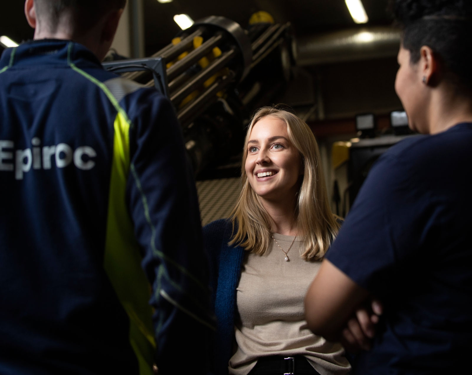 Three colleagues having a conversation with machine in the background, Slagsta 