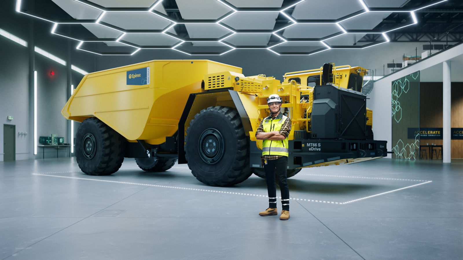 Wayne Symes in front of Minetruck MT66 S eDrive in a lab environment